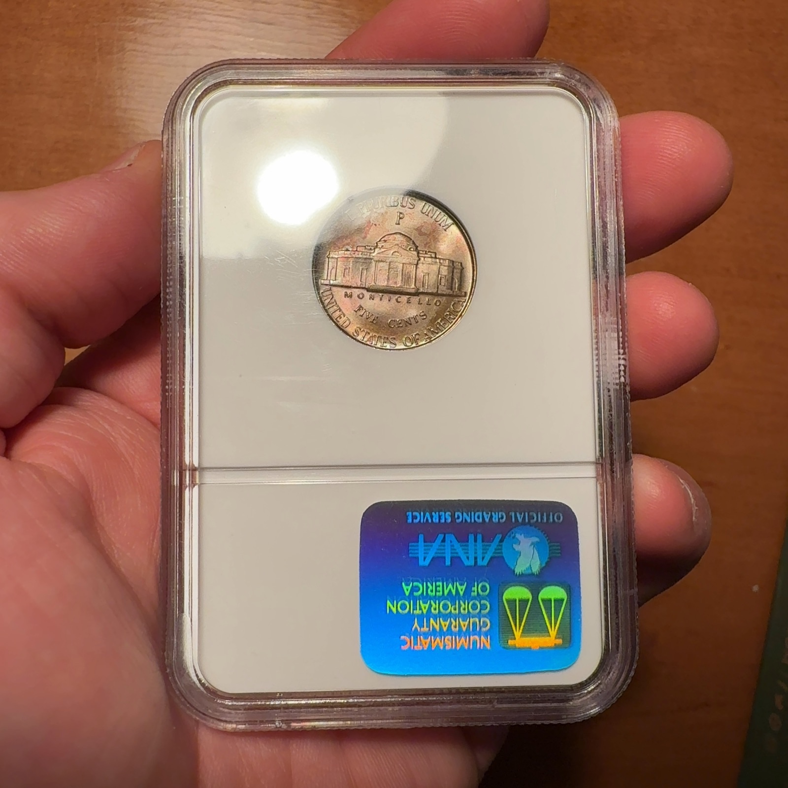 Handheld phone photograph 6 of the 1945-P Jefferson Nickel in its holder