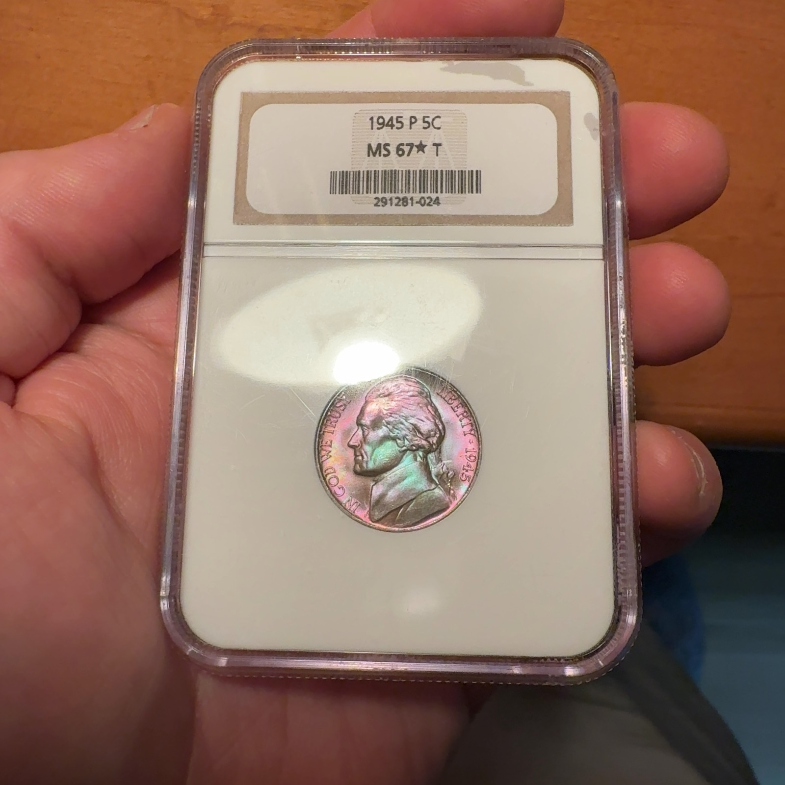 Handheld phone photograph 3 of the 1945-P Jefferson Nickel in its holder