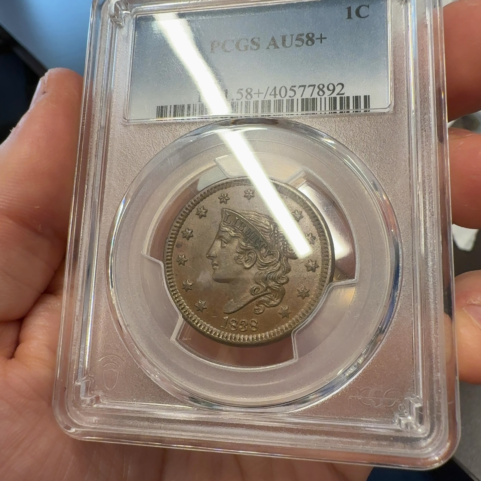 Handheld phone photograph 4 of the 1838 Coronet Large Cent in its holder