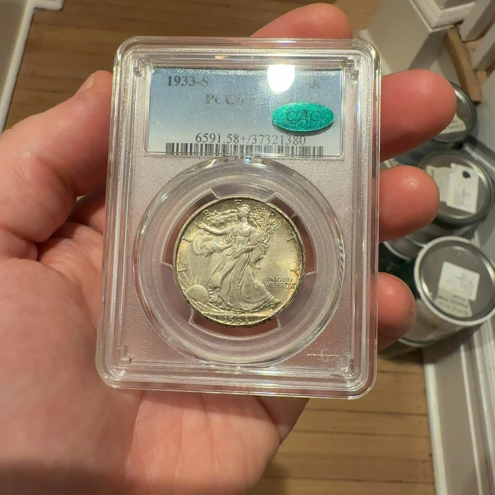 Handheld phone photograph 1 of the 1933-S Walking Liberty Half in its holder