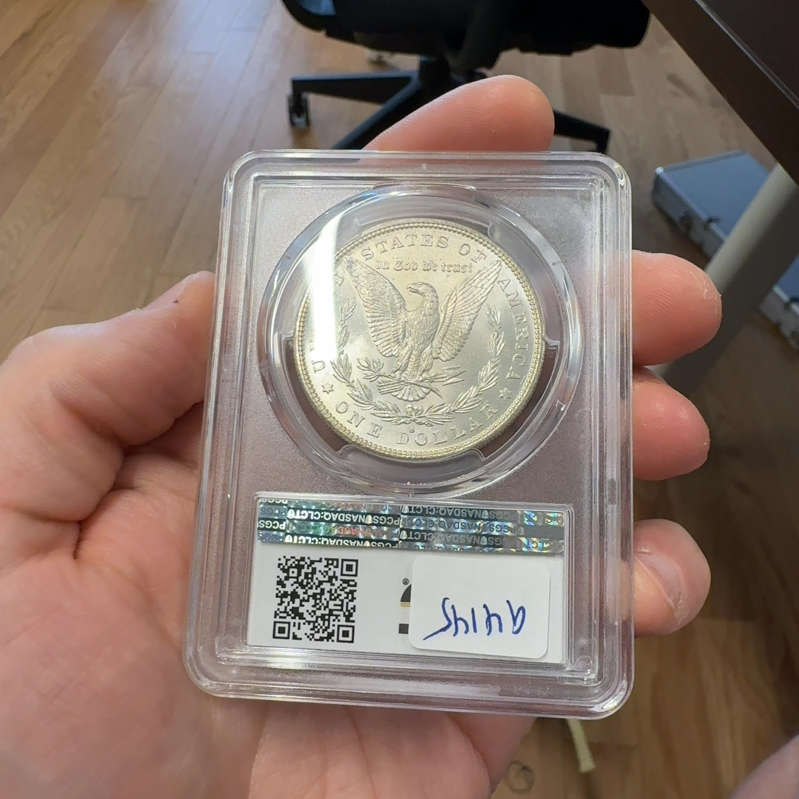 Handheld phone photograph 7 of the 1882-S Morgan Dollar in its holder