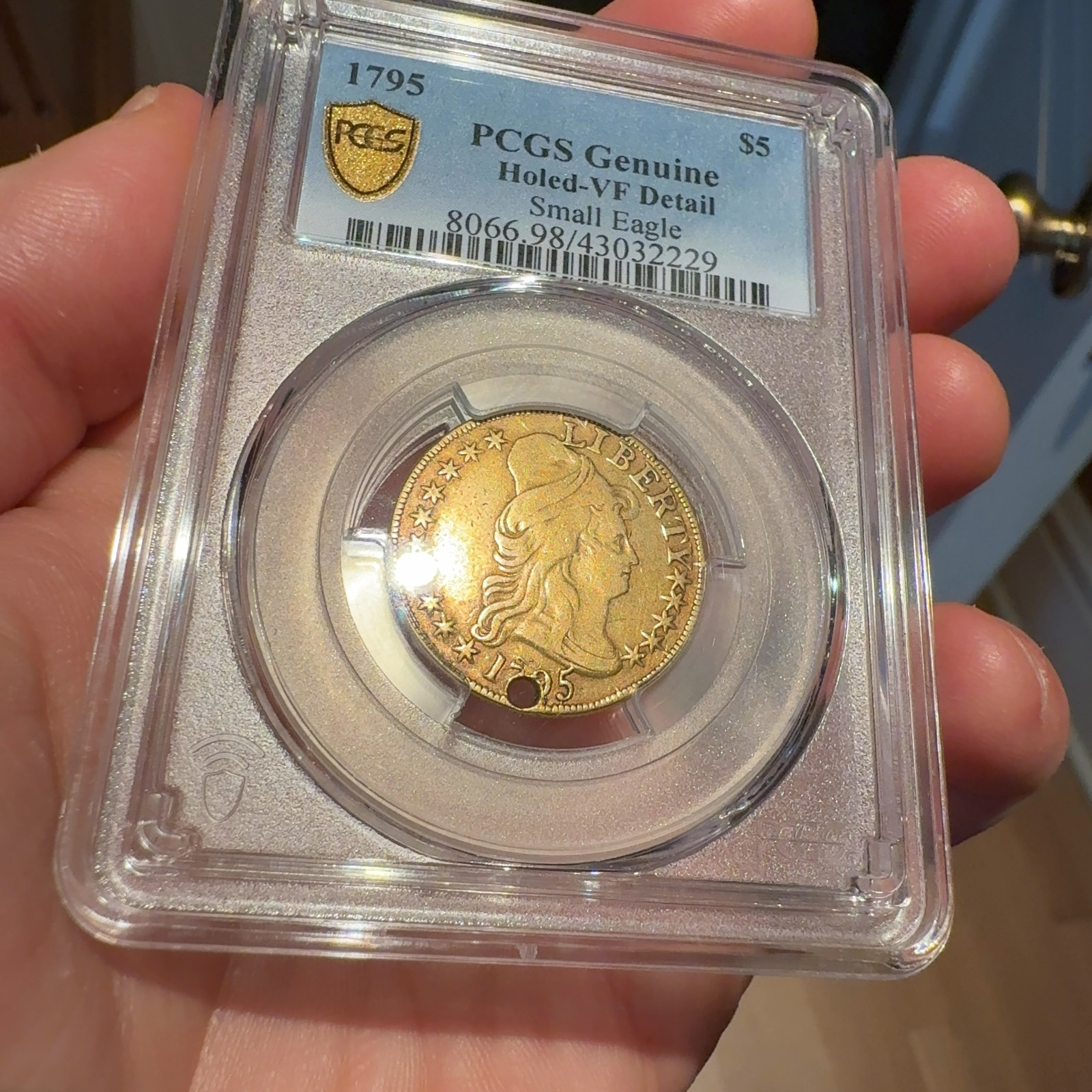 Handheld phone photograph 4 of the 1795 Half Eagle in its holder