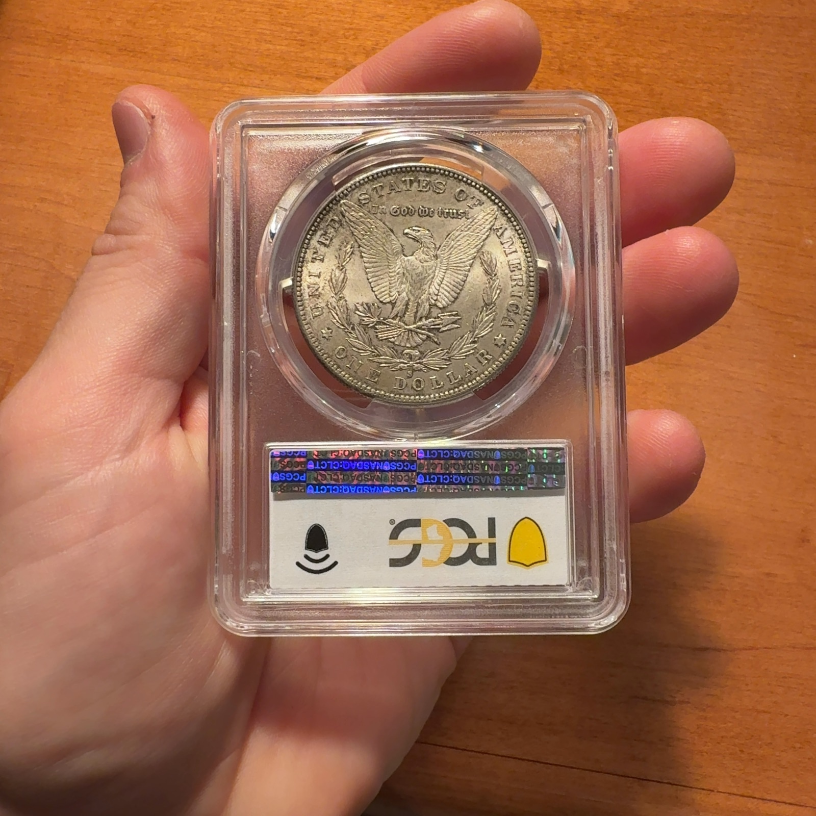 Handheld phone photograph 5 of the 1884-S Morgan Dollar in its holder
