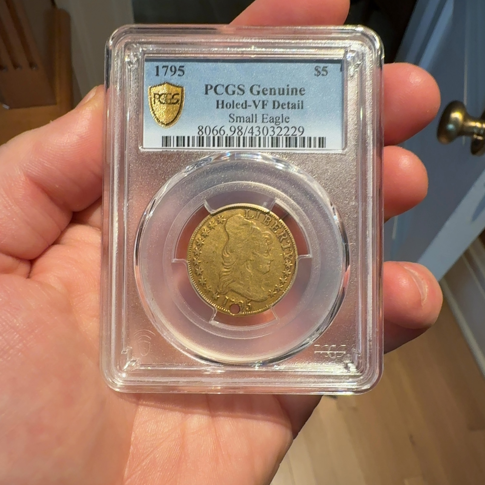 Handheld phone photograph 1 of the 1795 Half Eagle in its holder