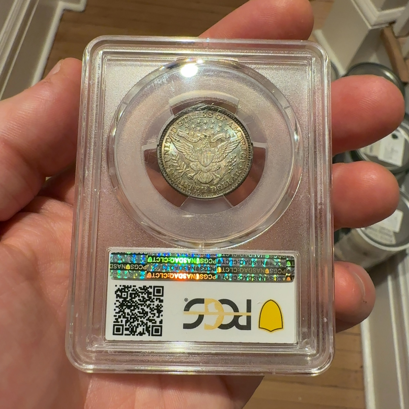 Handheld phone photograph 5 of the 1892 Barber Quarter in its holder