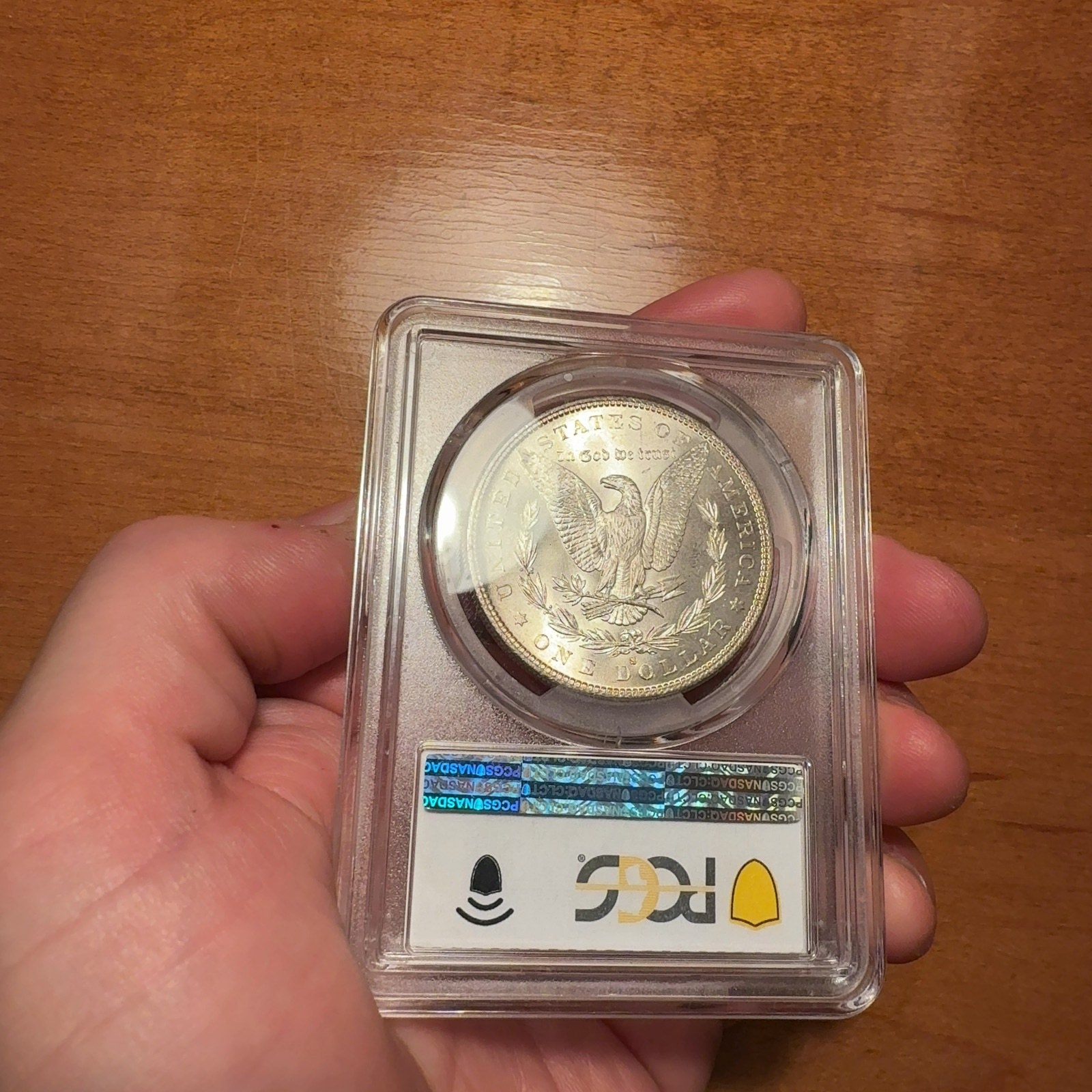Handheld phone photograph 8 of the 1882-S Silver Dollar in its holder