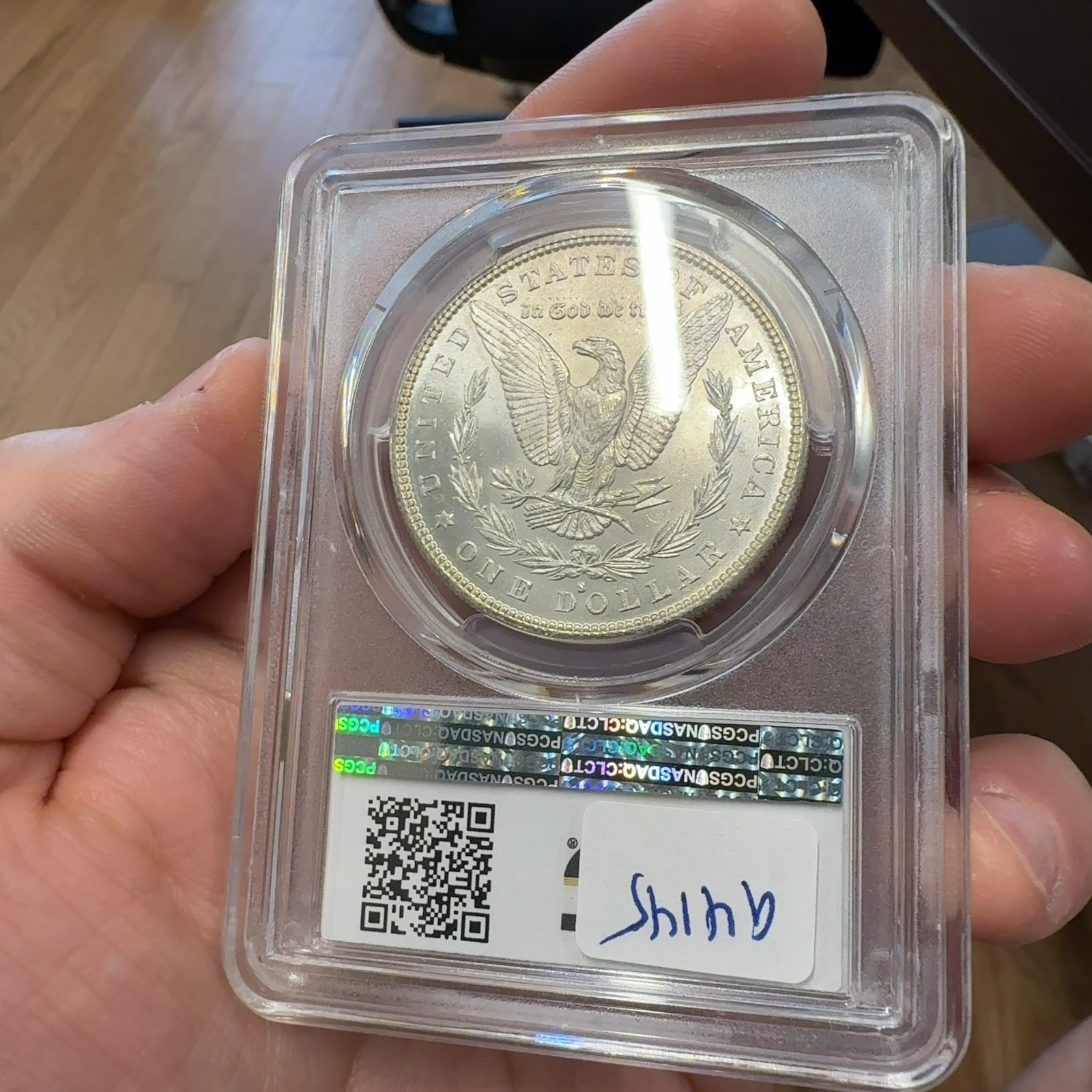 Handheld phone photograph 8 of the 1882-S Morgan Dollar in its holder