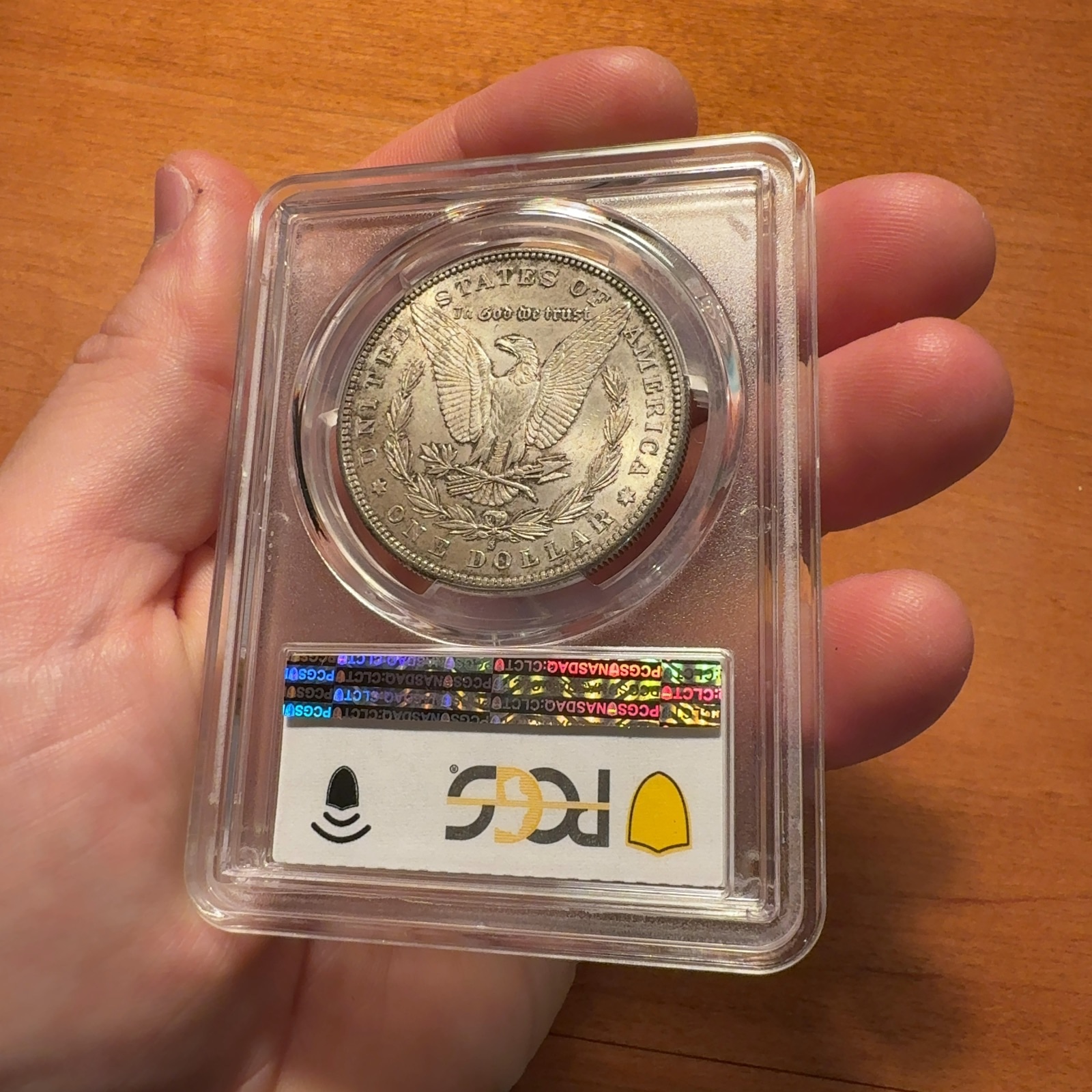 Handheld phone photograph 7 of the 1884-S Morgan Dollar in its holder