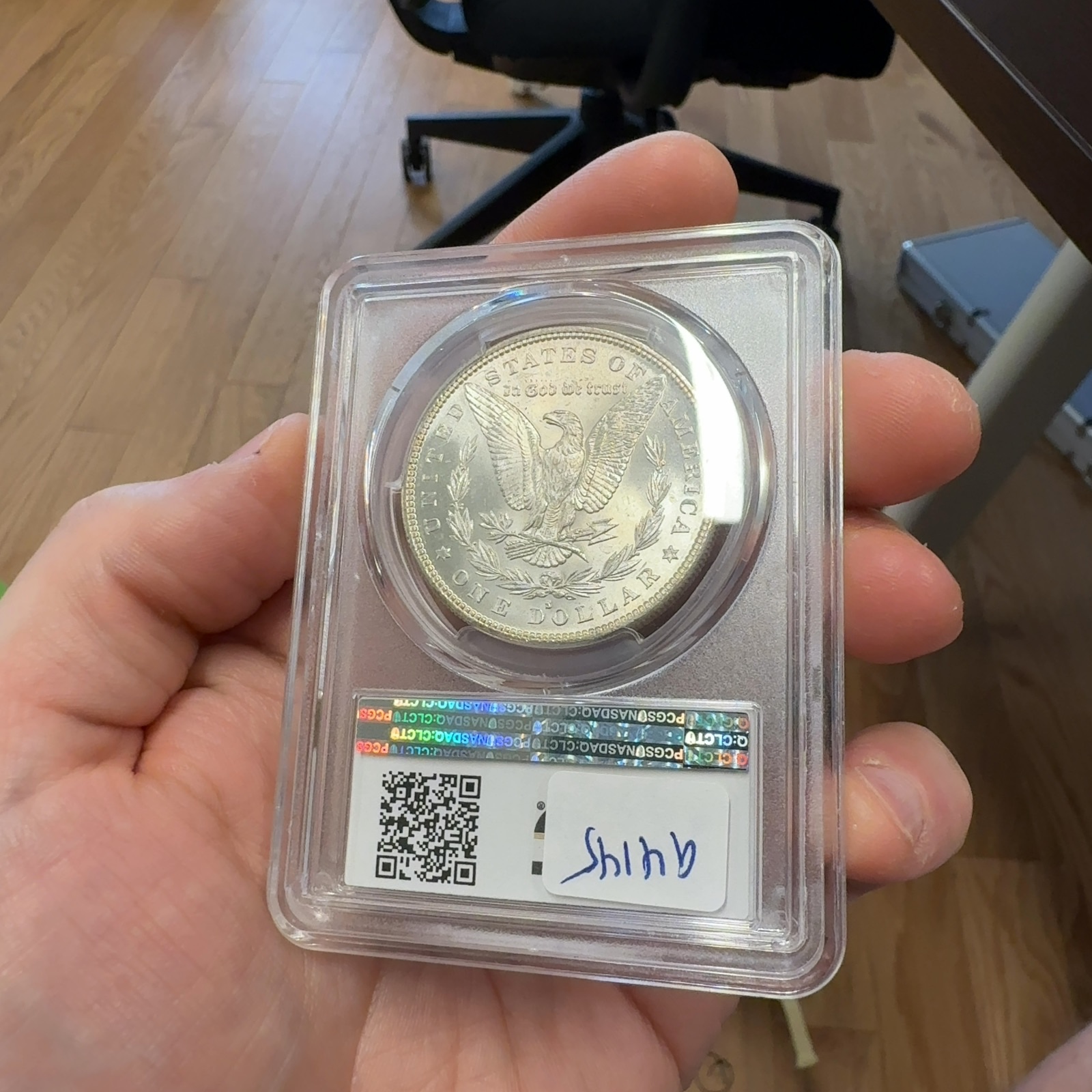 Handheld phone photograph 6 of the 1882-S Morgan Dollar in its holder