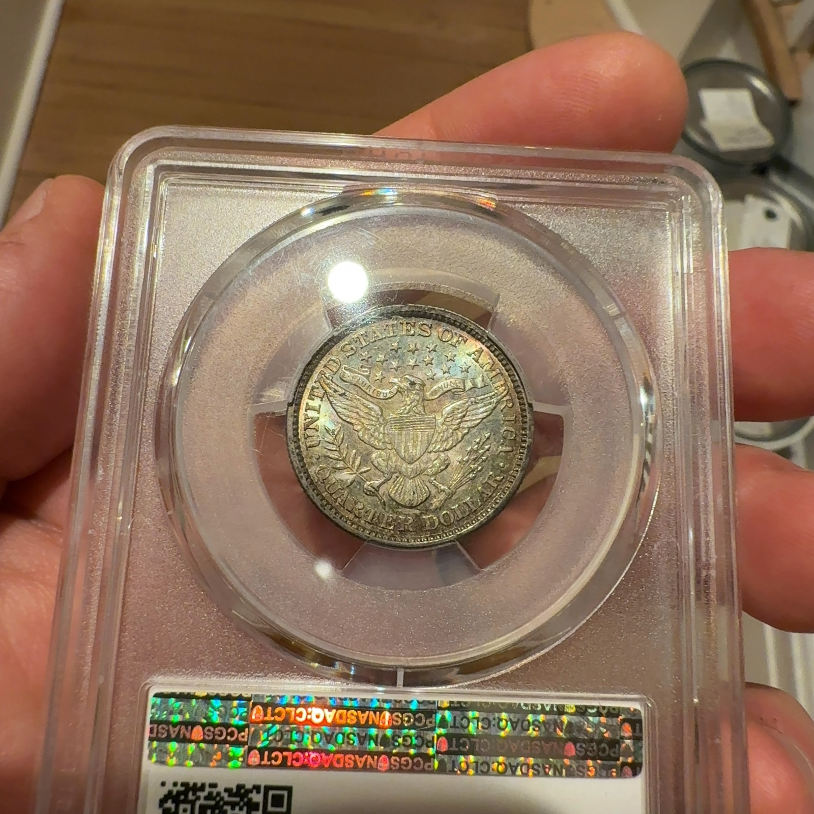 Handheld phone photograph 6 of the 1892 Barber Quarter in its holder