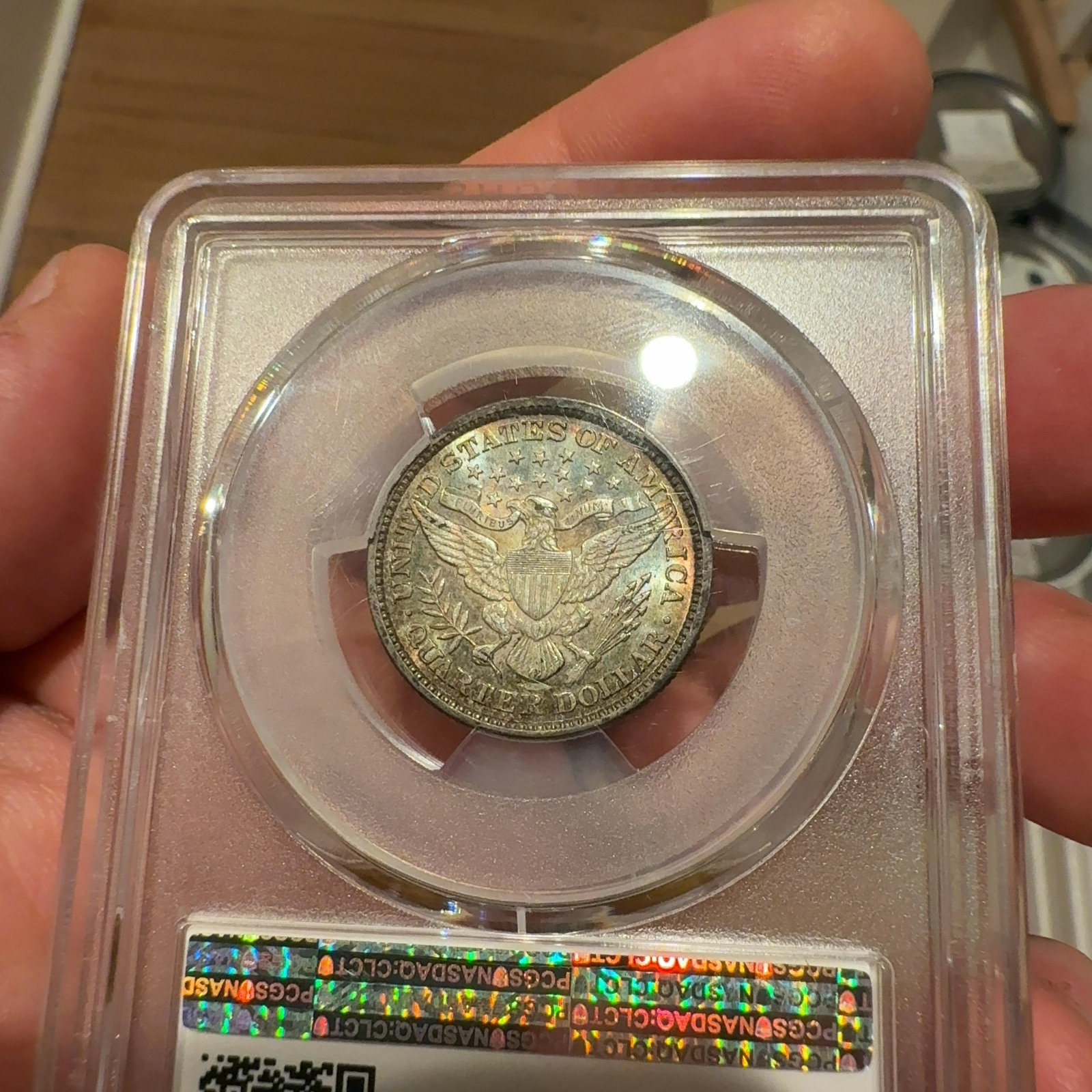Handheld phone photograph 7 of the 1892 Barber Quarter in its holder