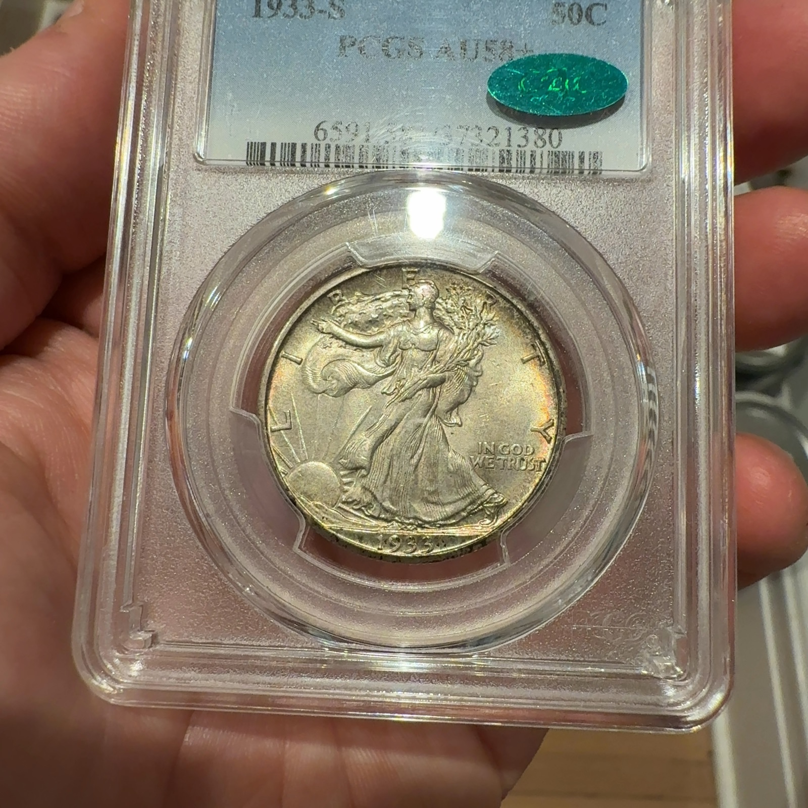 Handheld phone photograph 2 of the 1933-S Walking Liberty Half in its holder