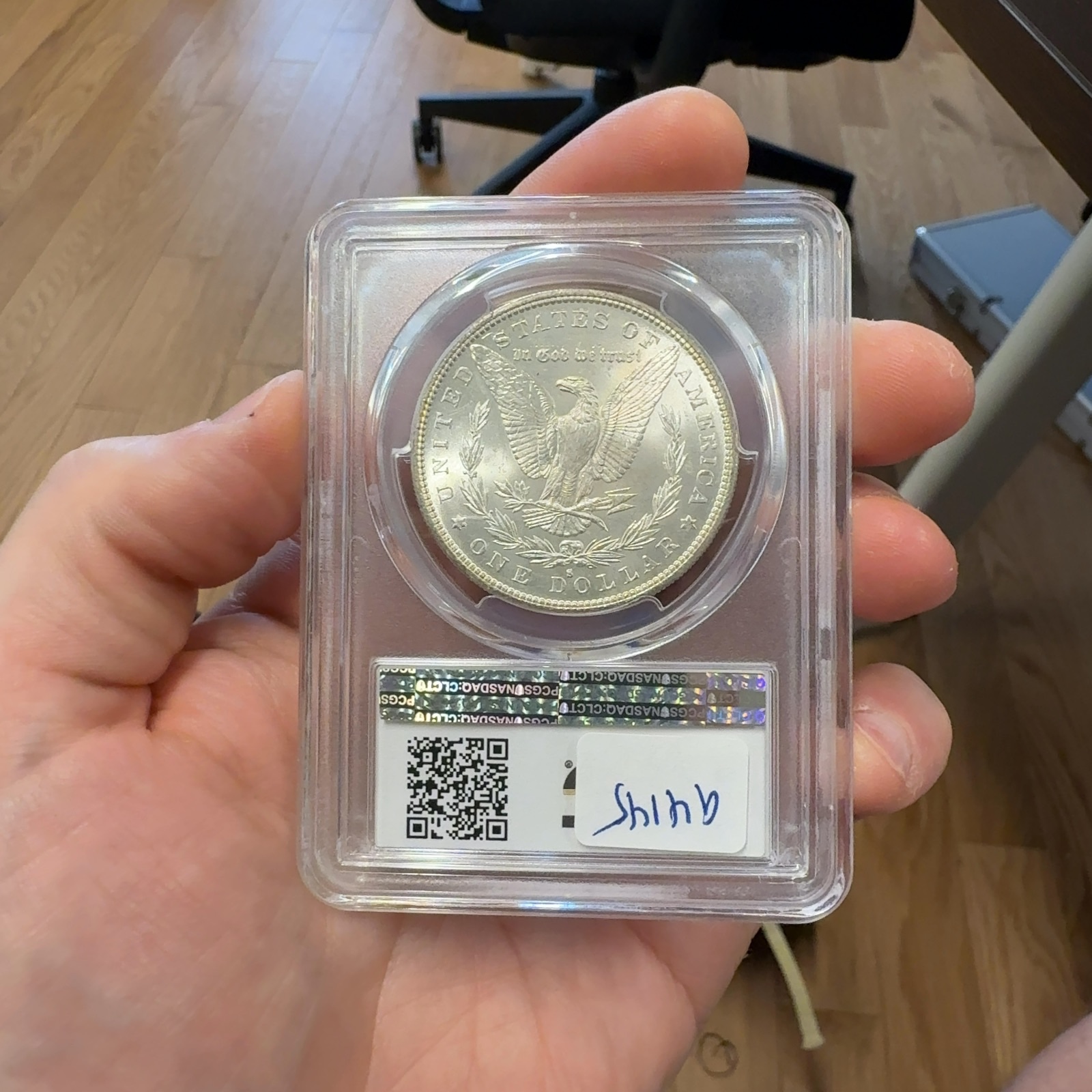 Handheld phone photograph 5 of the 1882-S Morgan Dollar in its holder
