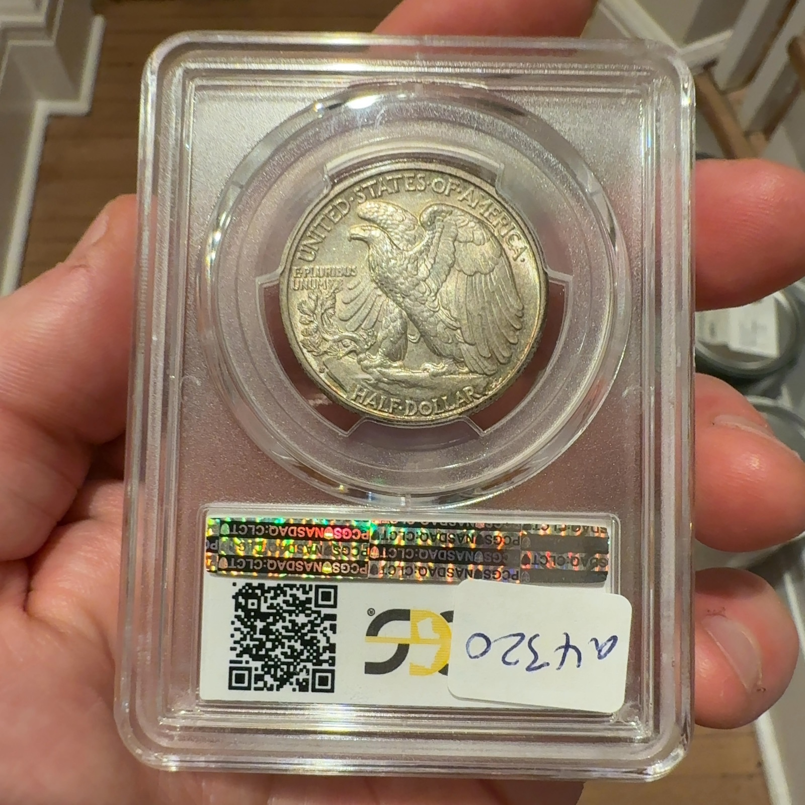 Handheld phone photograph 5 of the 1933-S Walking Liberty Half in its holder