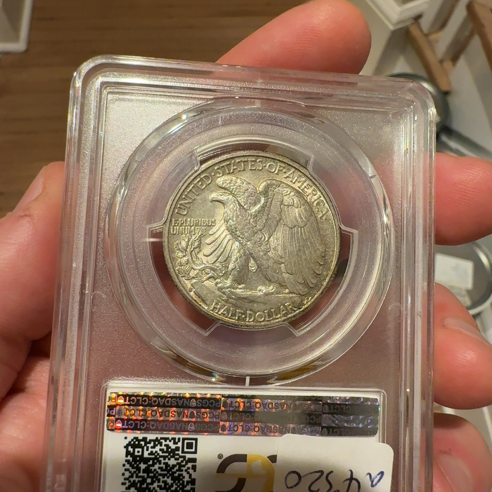 Handheld phone photograph 8 of the 1933-S Walking Liberty Half in its holder