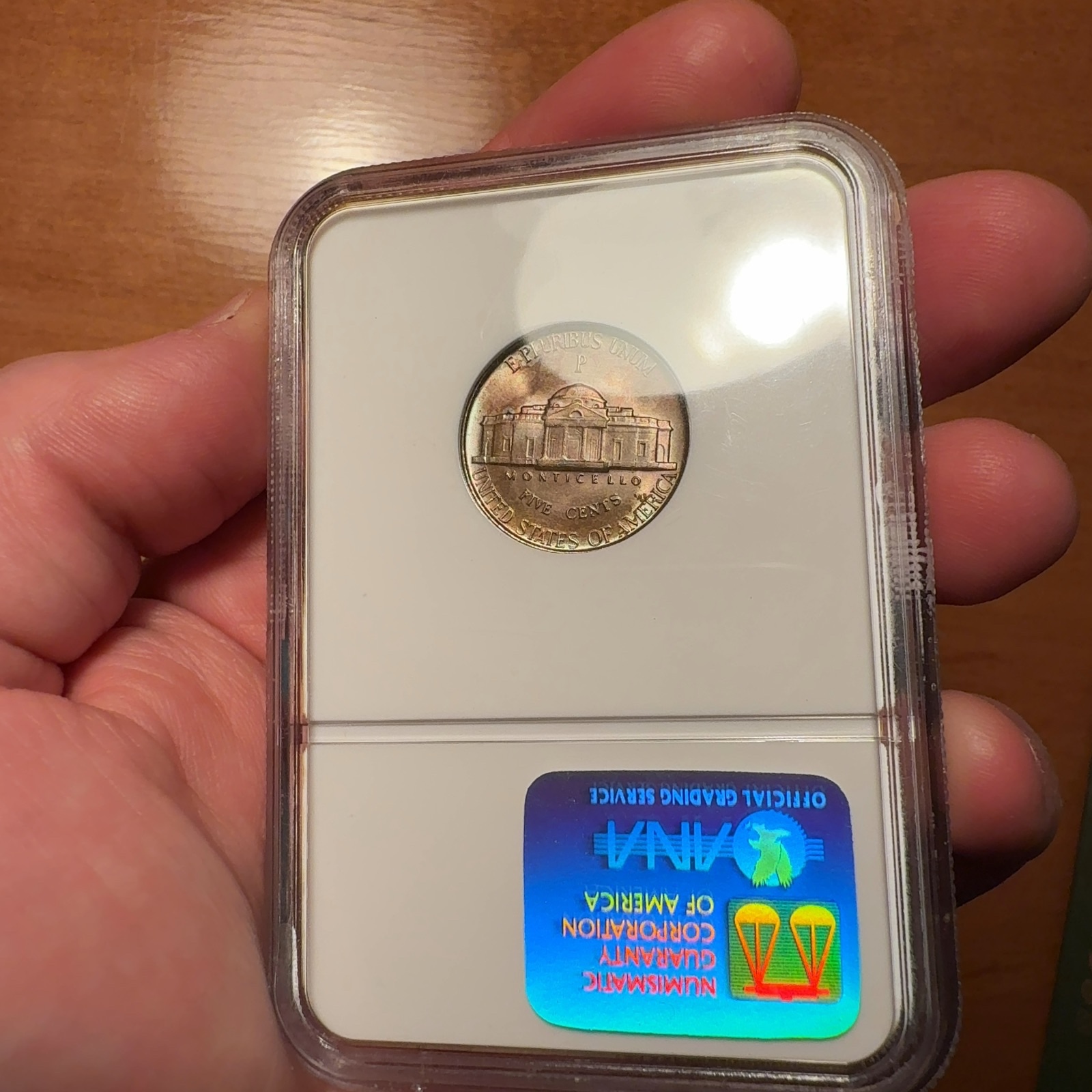 Handheld phone photograph 7 of the 1945-P Jefferson Nickel in its holder