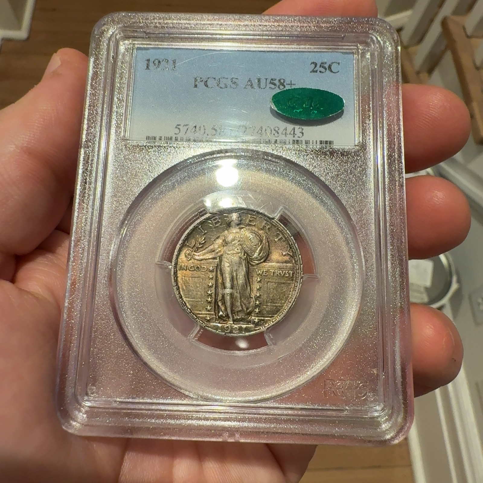 Handheld phone photograph 3 of the 1921 Standing Liberty Quarter in its holder