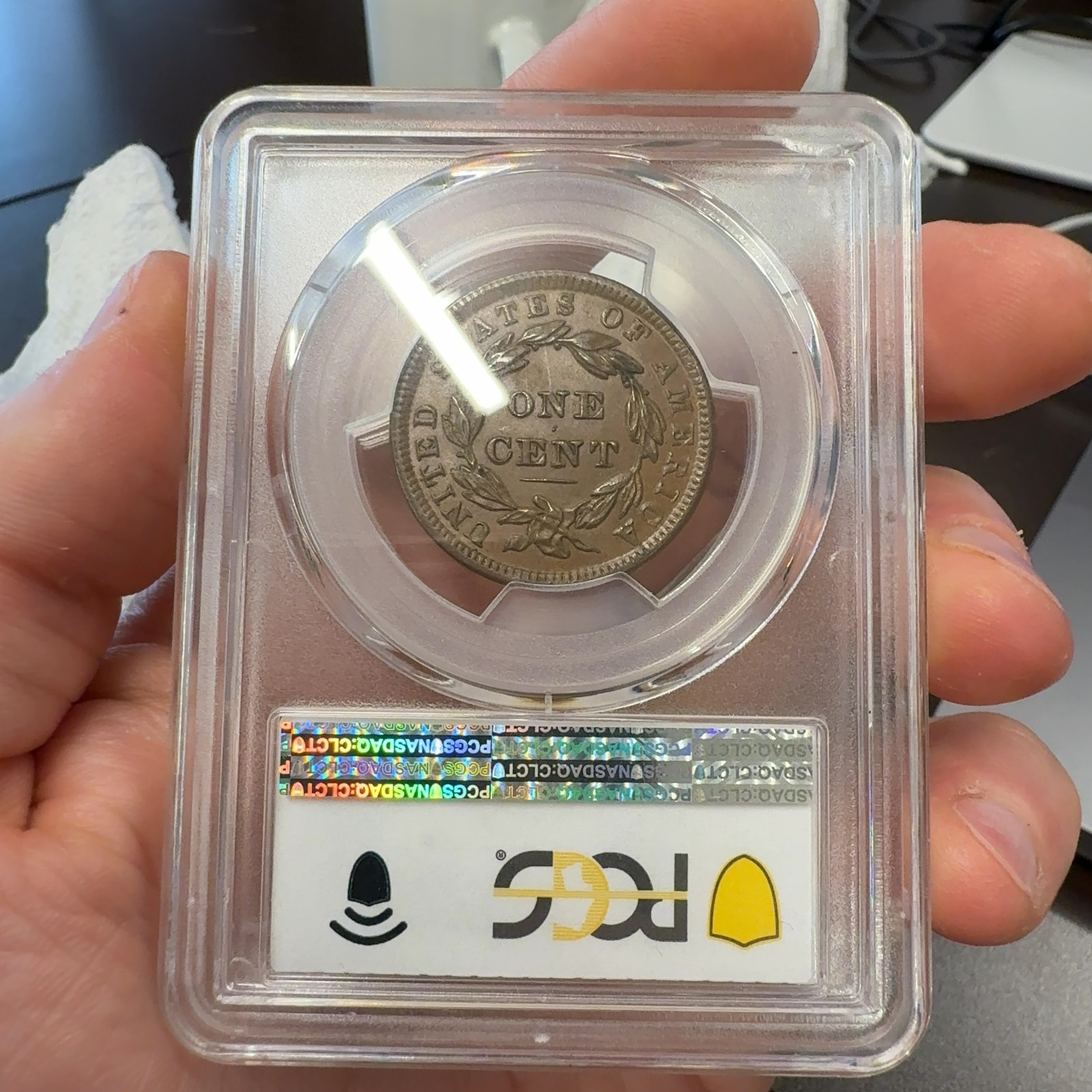 Handheld phone photograph 6 of the 1838 Coronet Large Cent in its holder