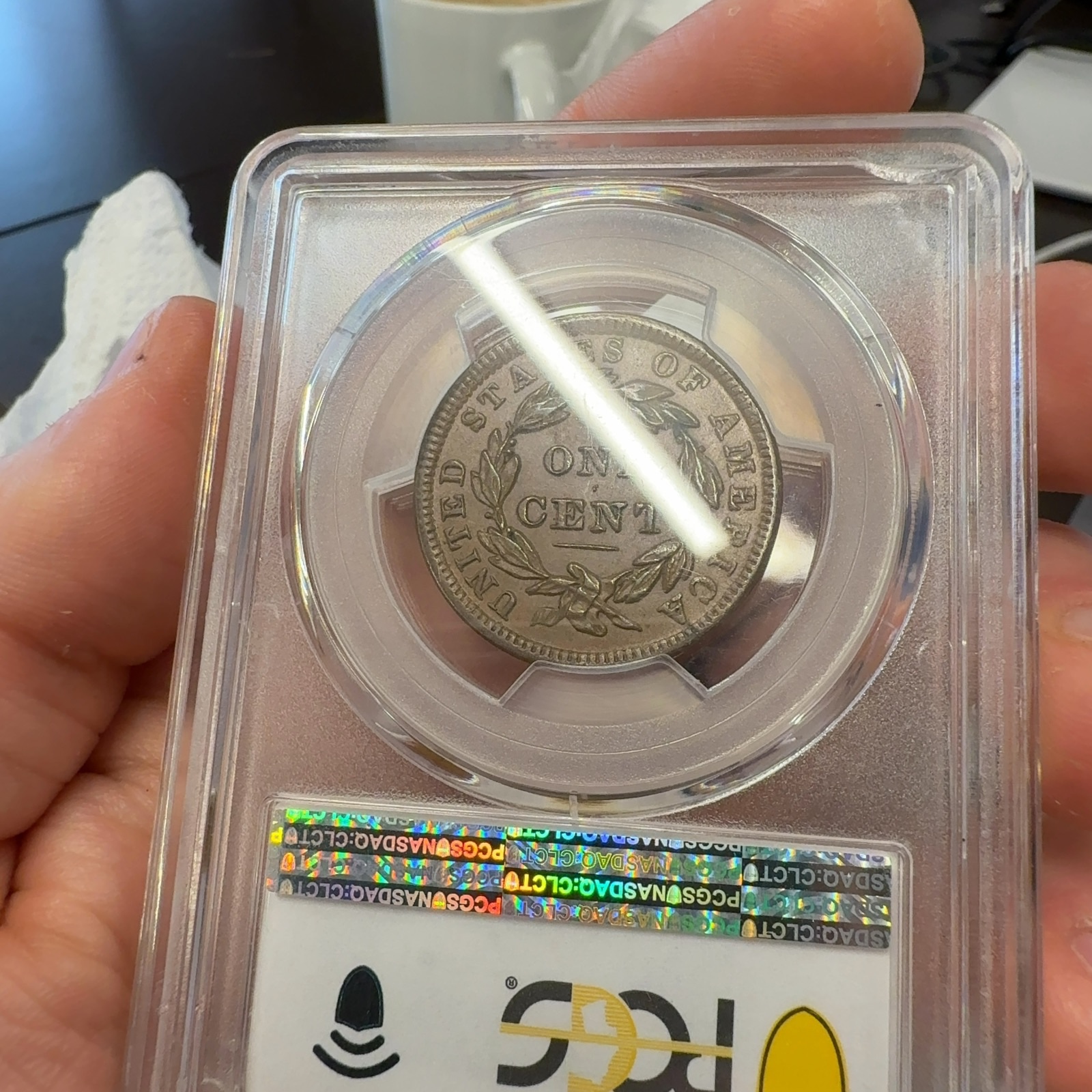 Handheld phone photograph 7 of the 1838 Coronet Large Cent in its holder