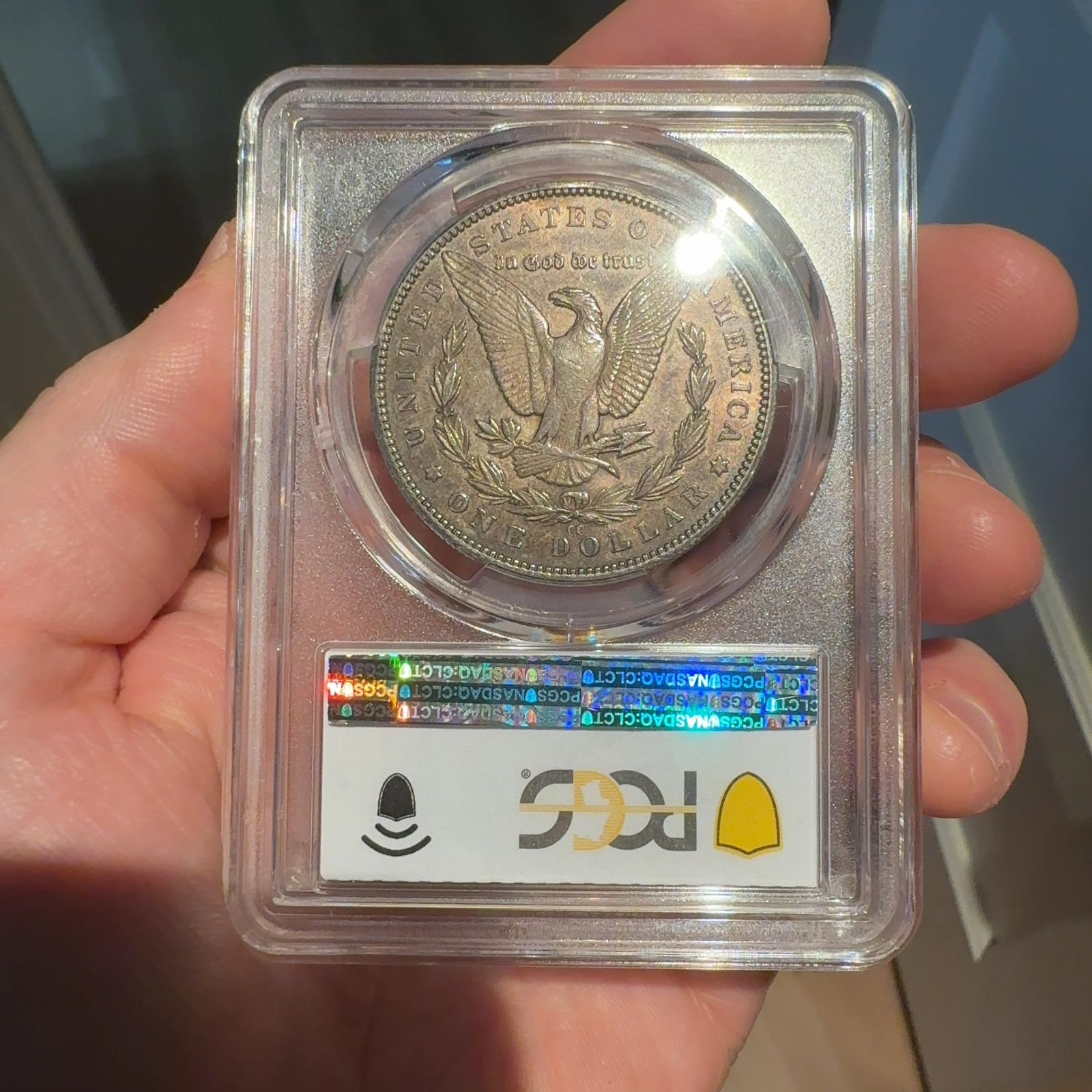 Handheld phone photograph 5 of the 1893-CC Morgan Dollar in its holder