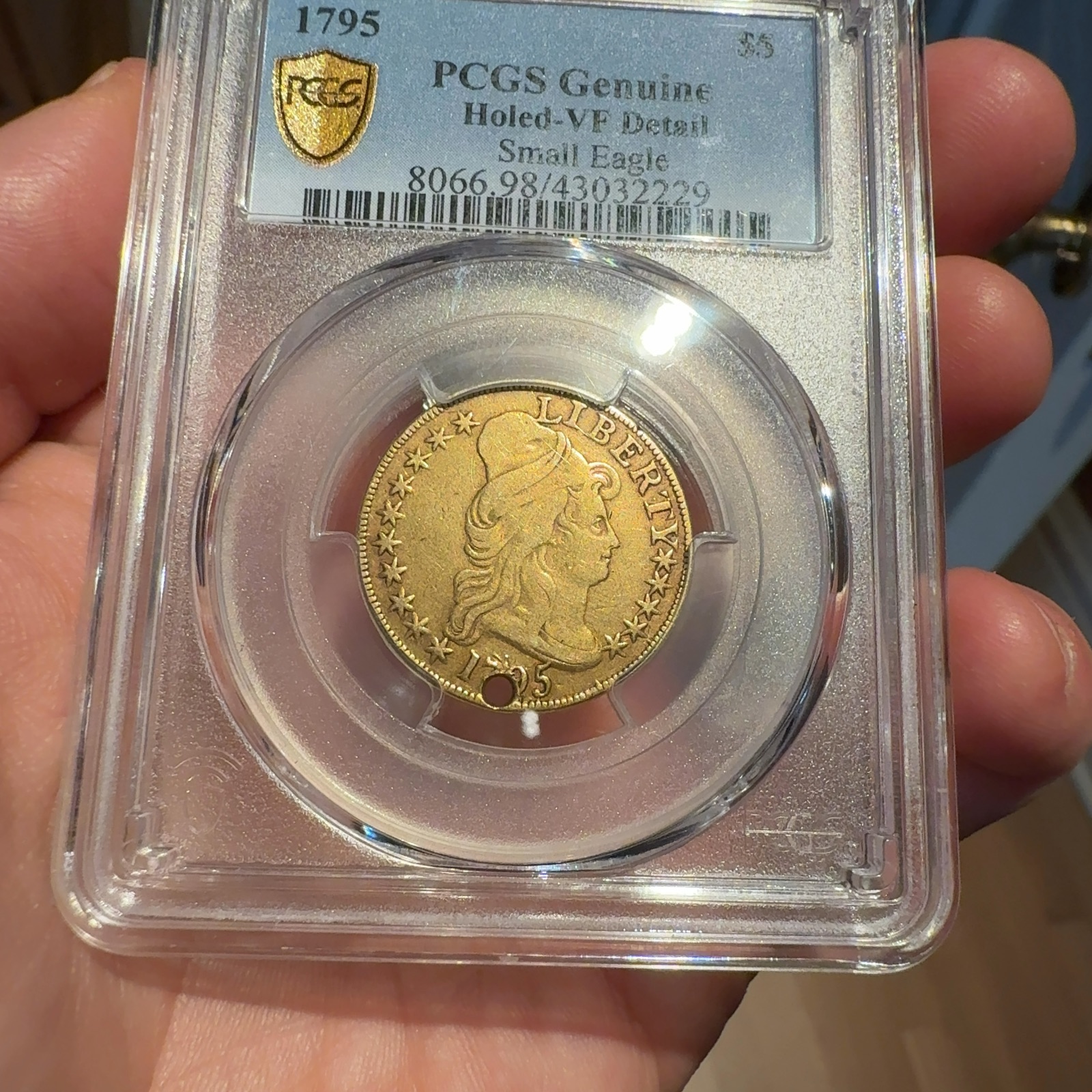 Handheld phone photograph 3 of the 1795 Half Eagle in its holder