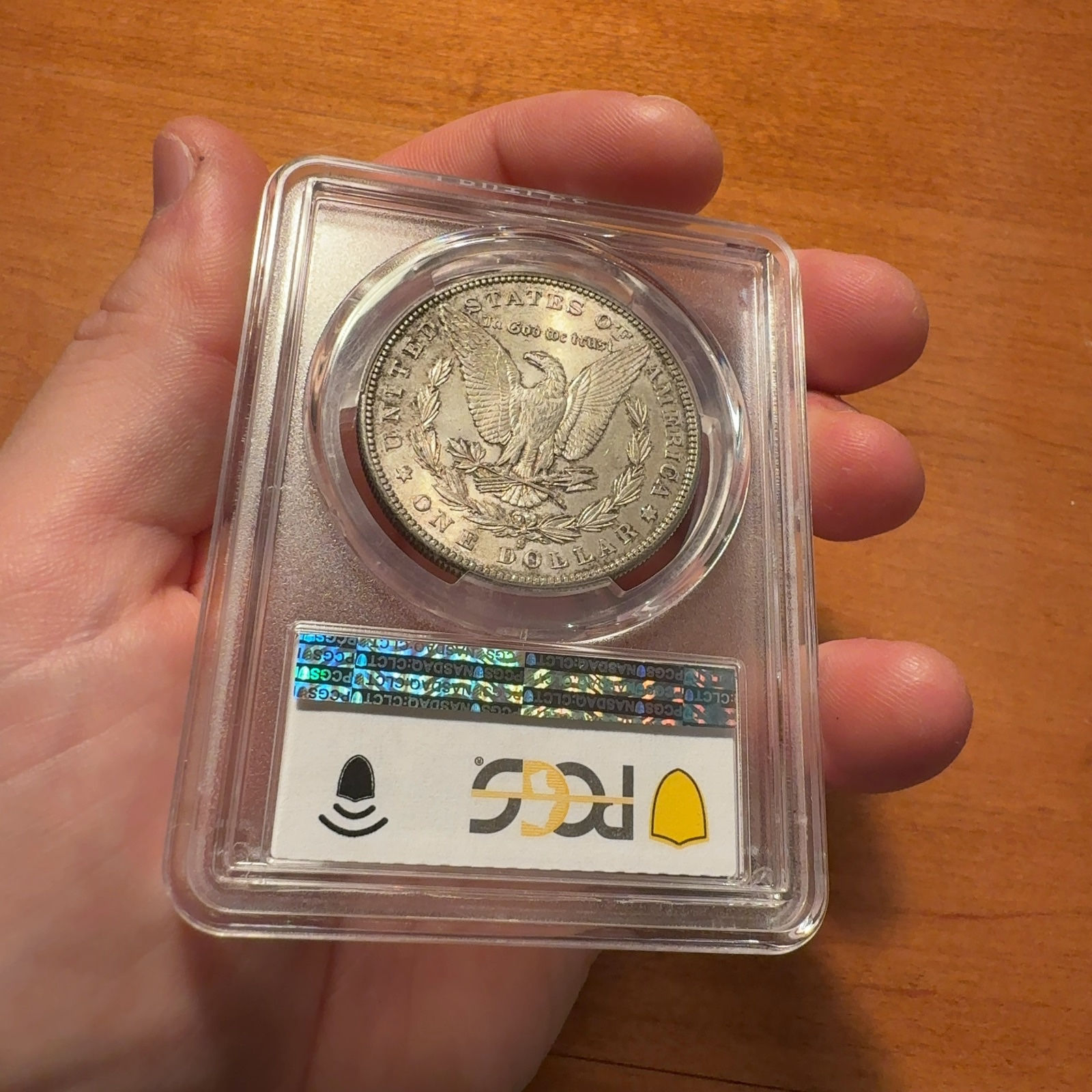Handheld phone photograph 8 of the 1884-S Morgan Dollar in its holder