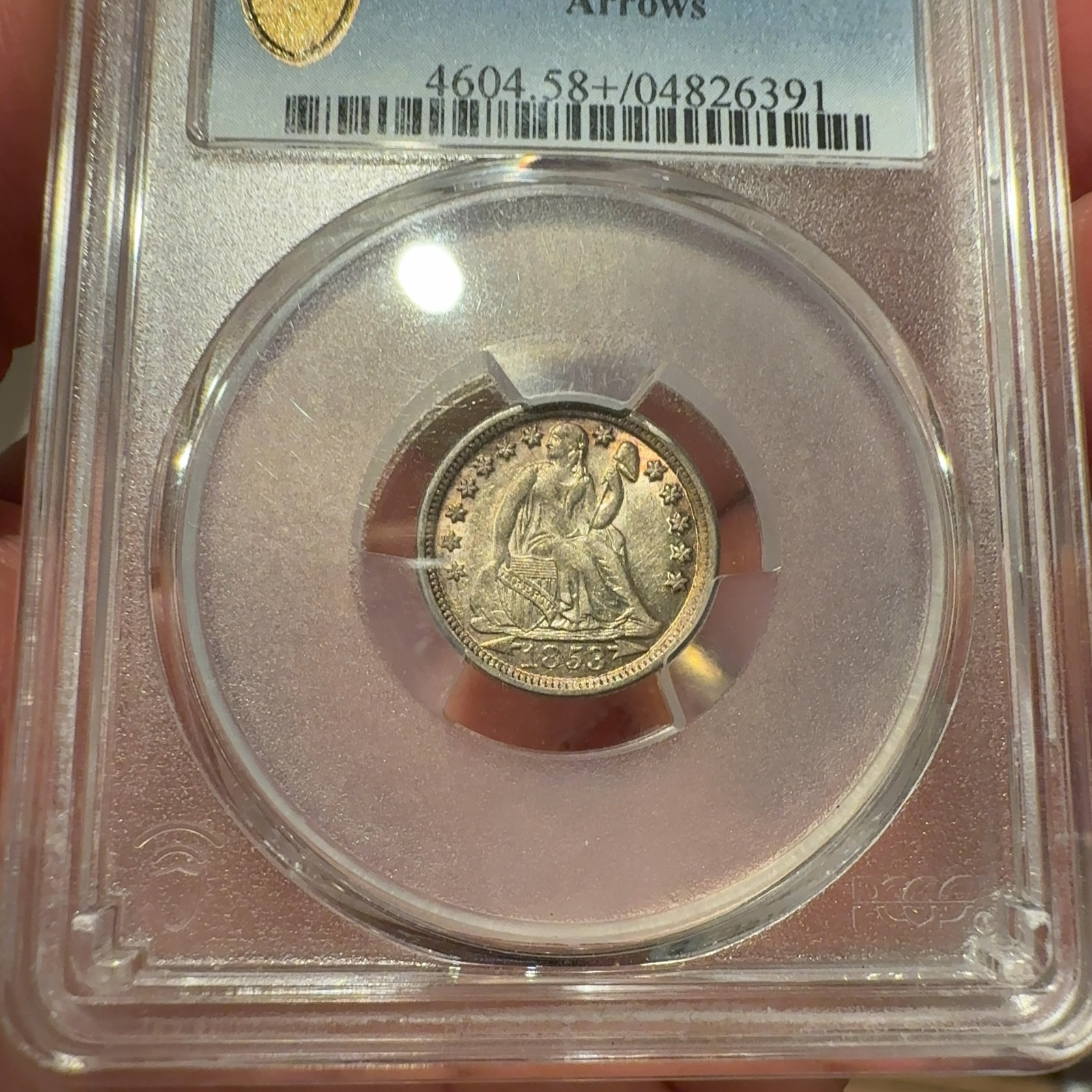 Handheld phone photograph 4 of the 1853-O Seated Liberty Dime in its holder