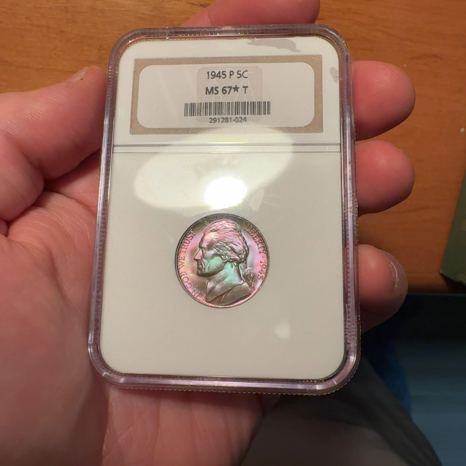 Handheld phone photograph 4 of the 1945-P Jefferson Nickel in its holder