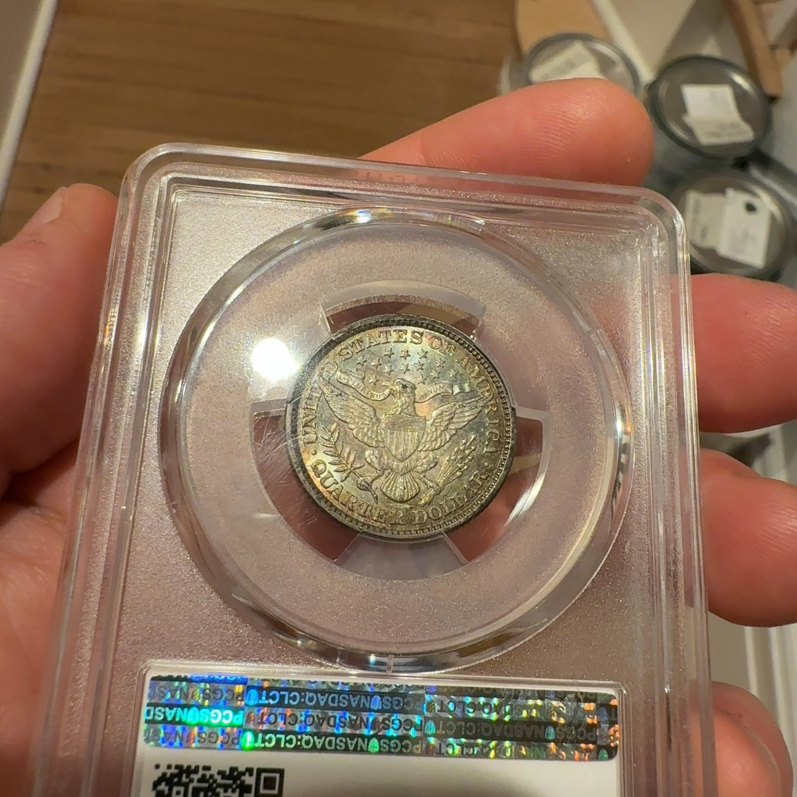 Handheld phone photograph 8 of the 1892 Barber Quarter in its holder