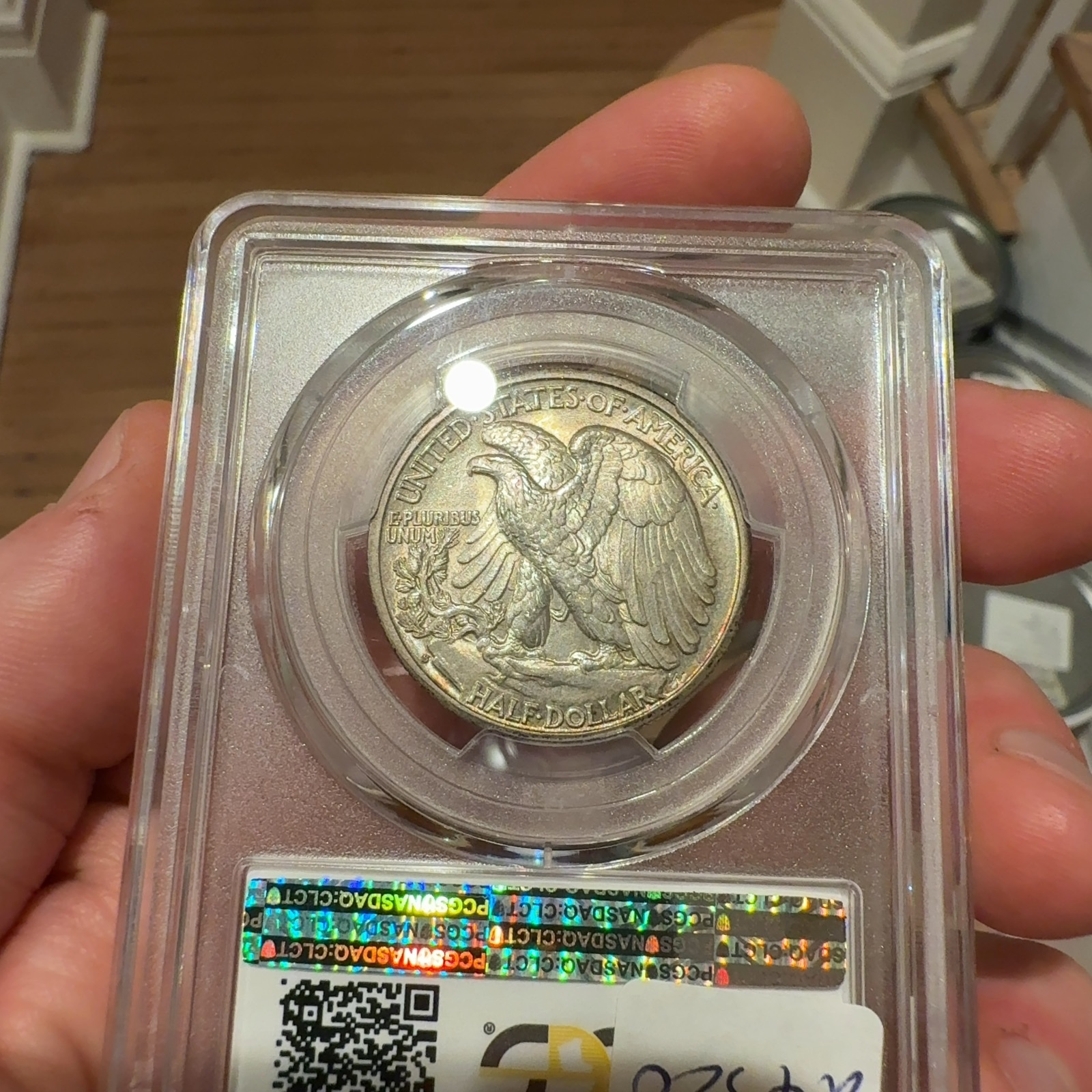 Handheld phone photograph 7 of the 1933-S Walking Liberty Half in its holder
