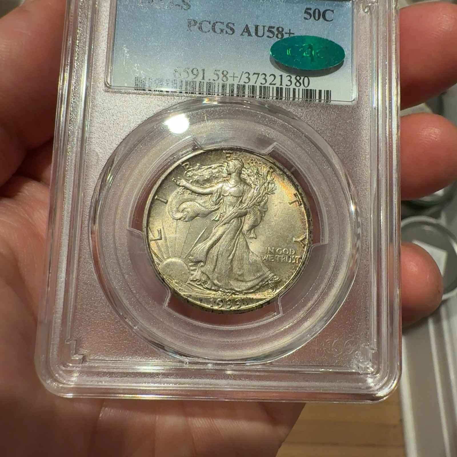 Handheld phone photograph 3 of the 1933-S Walking Liberty Half in its holder