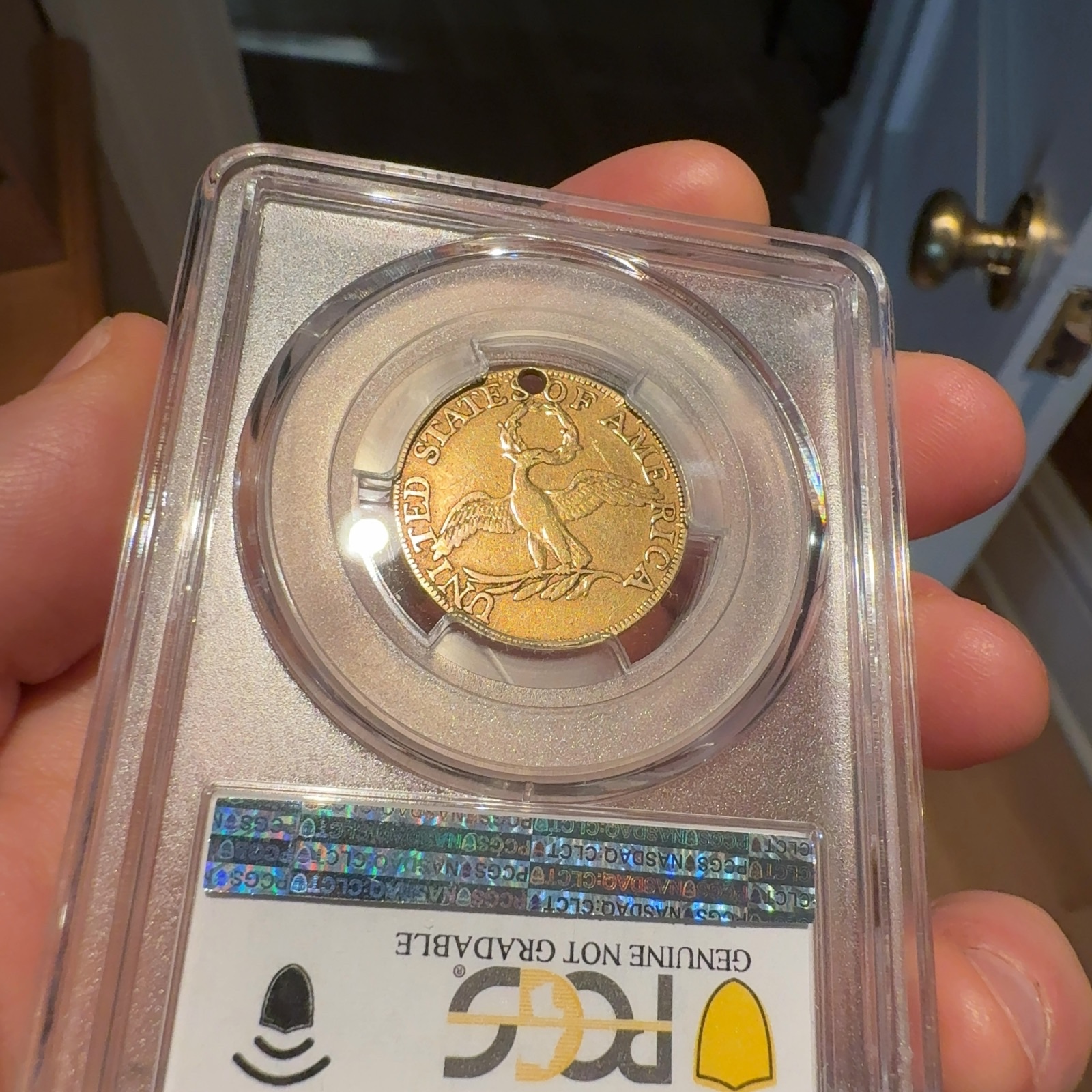 Handheld phone photograph 8 of the 1795 Half Eagle in its holder