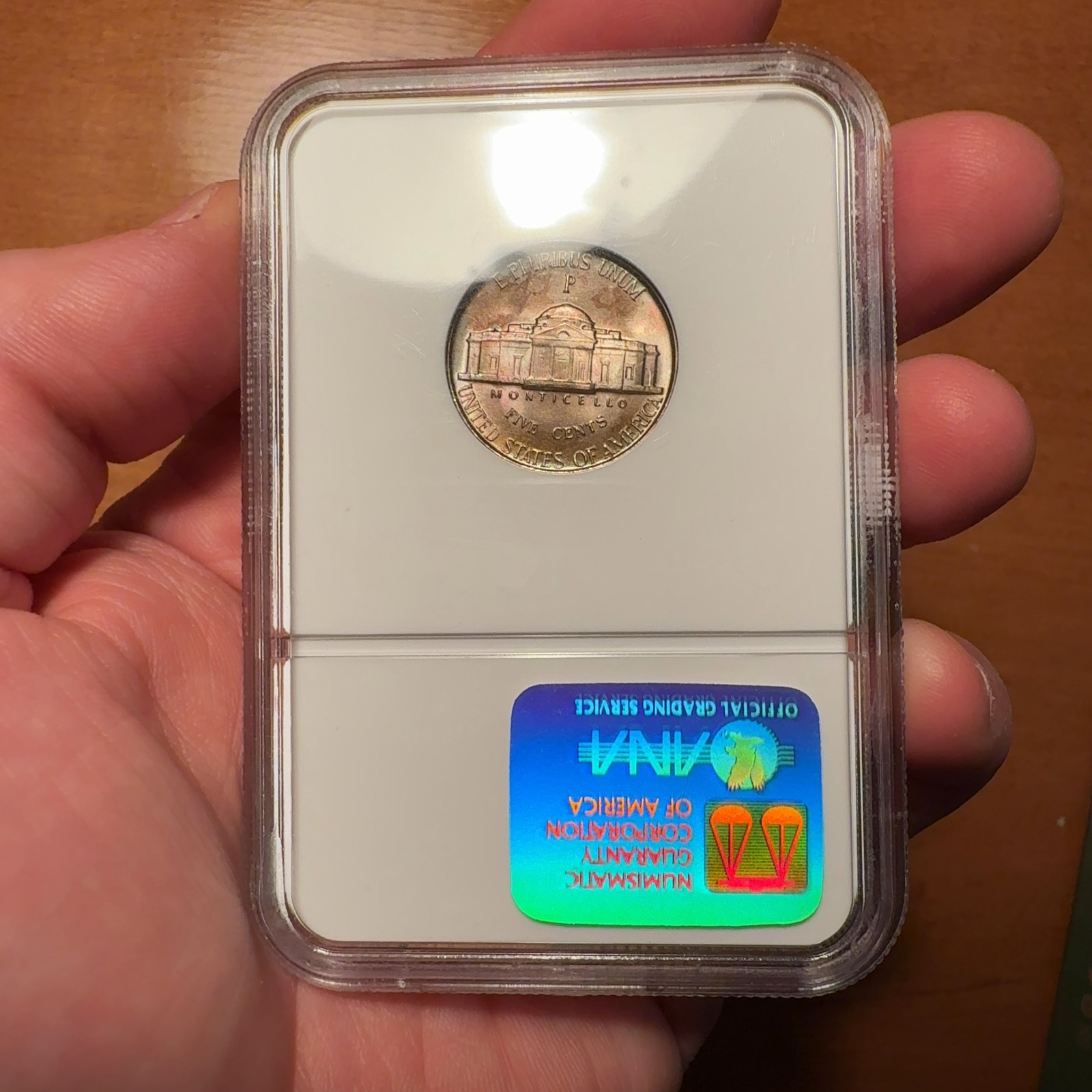 Handheld phone photograph 5 of the 1945-P Jefferson Nickel in its holder