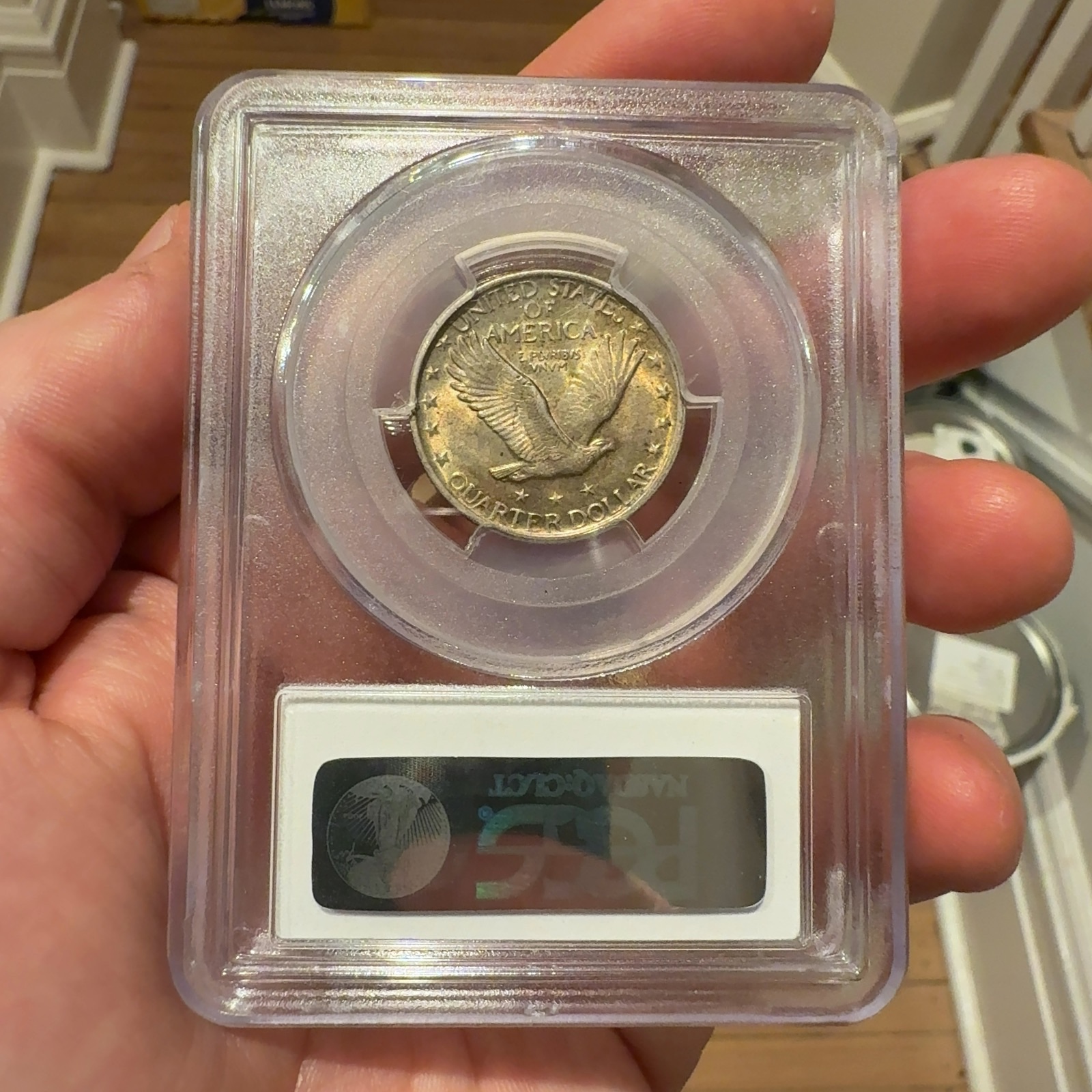 Handheld phone photograph 5 of the 1921 Standing Liberty Quarter in its holder