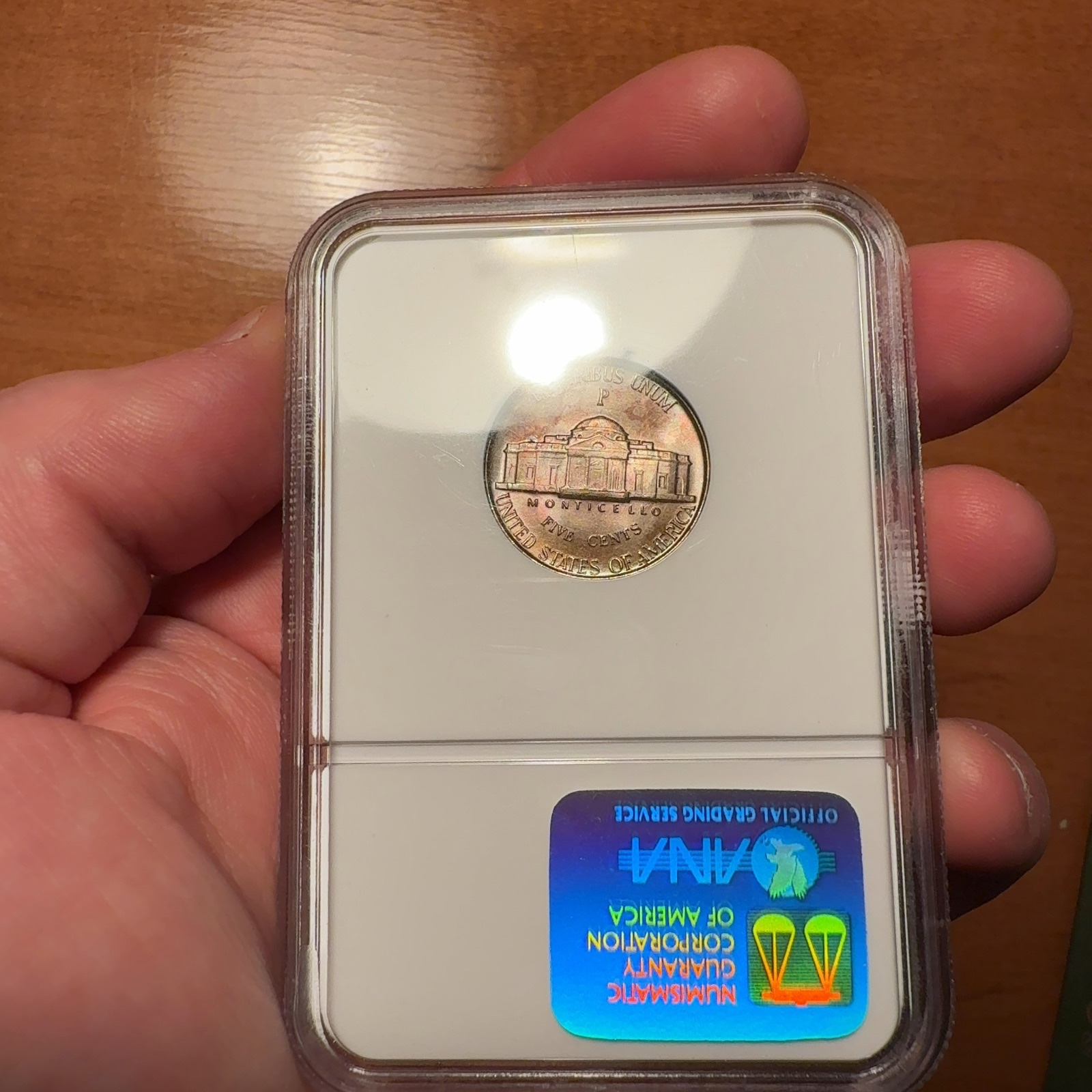 Handheld phone photograph 8 of the 1945-P Jefferson Nickel in its holder