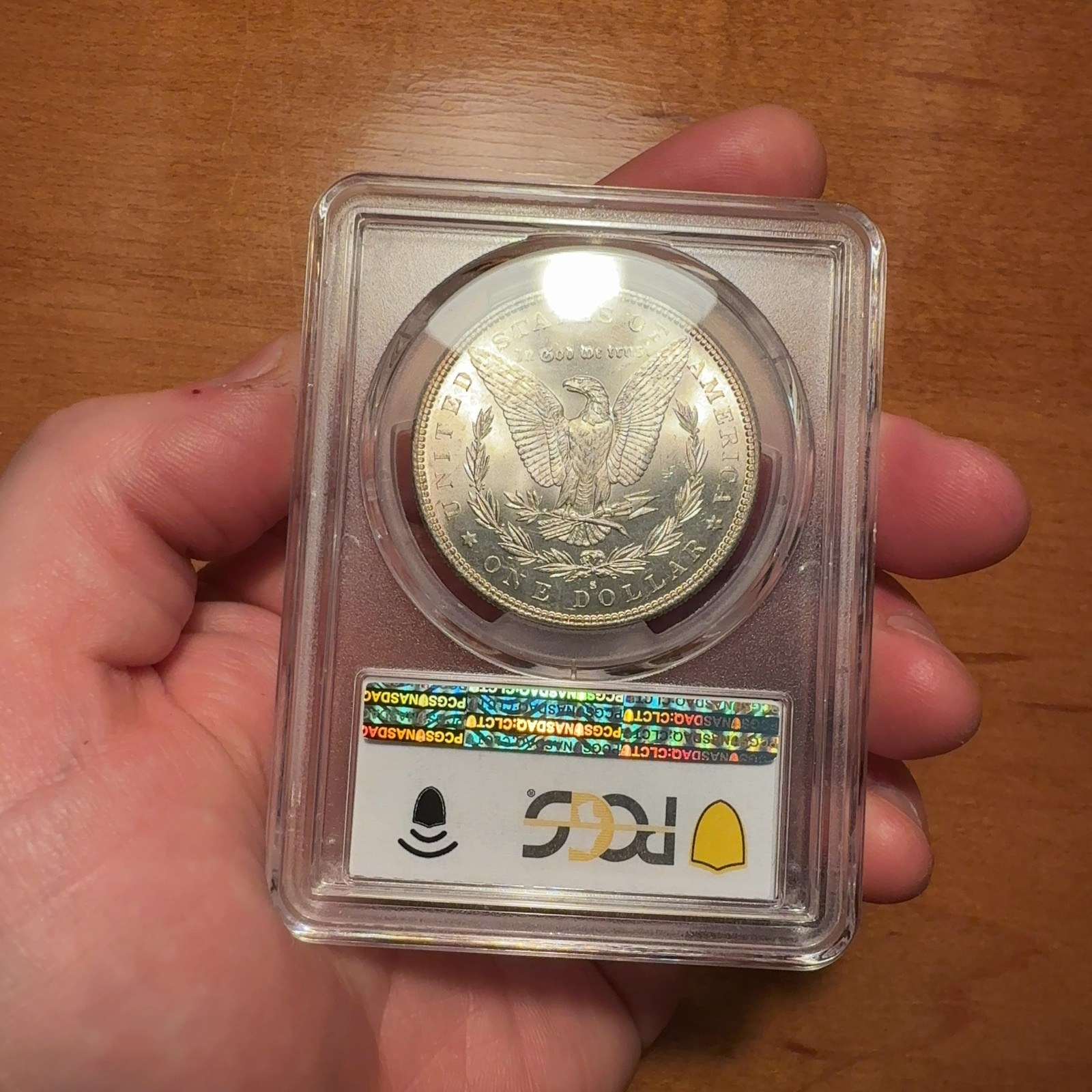 Handheld phone photograph 5 of the 1882-S Silver Dollar in its holder